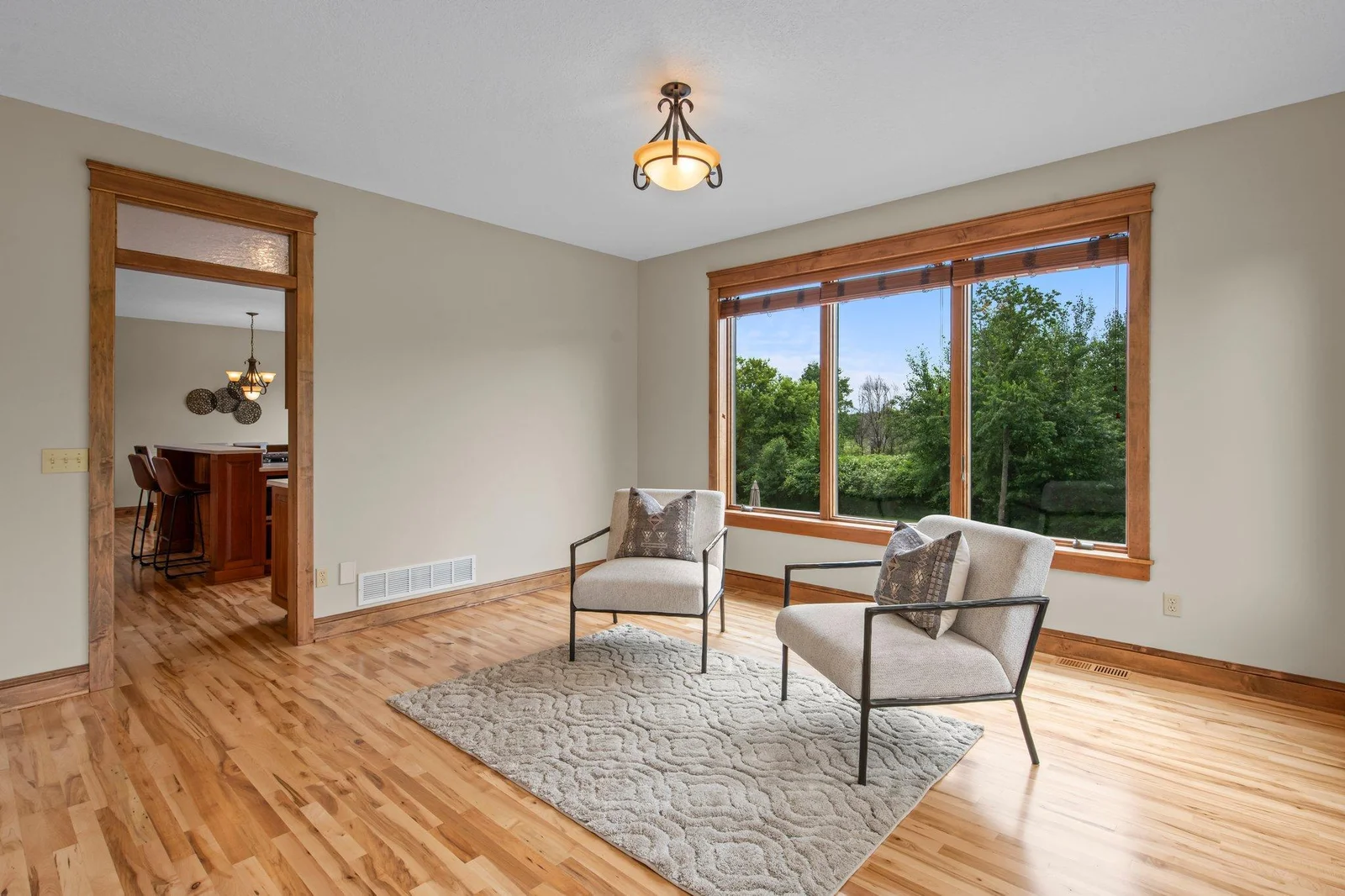 The family room features hardwood floors and windows overlooking the backyard.