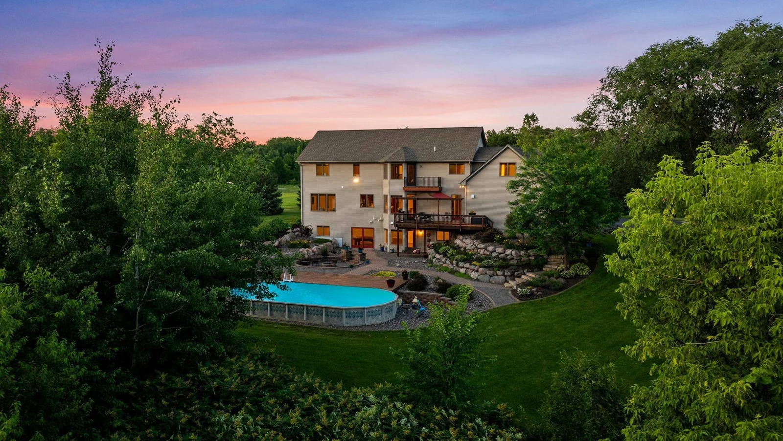 The backyard is an oasis, featuring stunning landscaping and a pool.