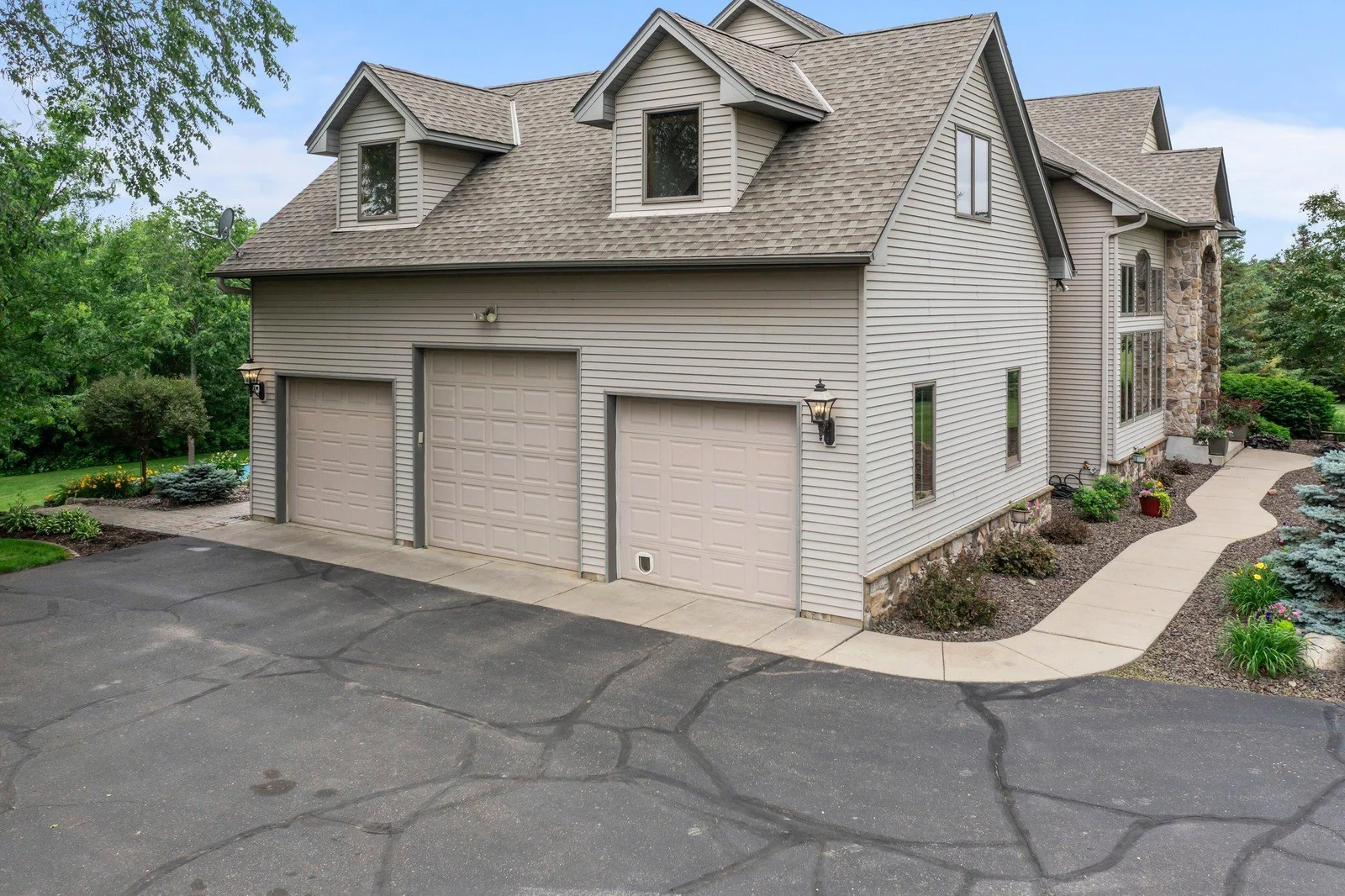 This home features an asphault driveway and an attached heated and insulated 3-car garage.