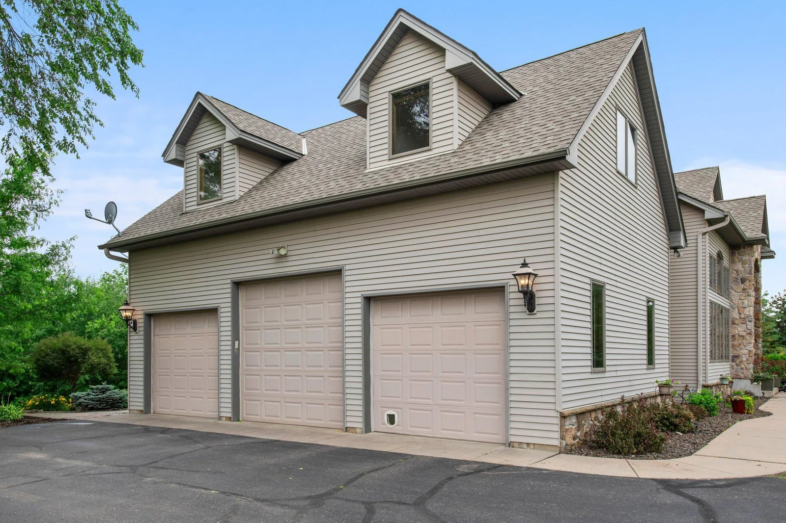 This home features an asphault driveway and an attached heated and insulated 3-car garage.
