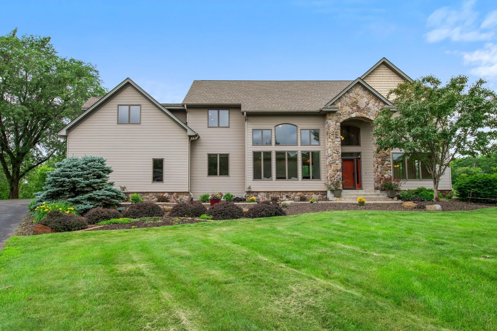 This home features aluminum siding and a stone archway over the front porch.
