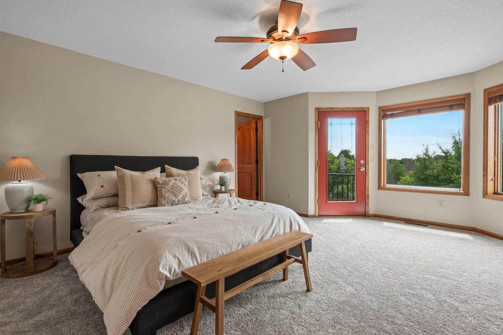 The primary suite features a massive walk-in closet, private bathroom and a balcony overlooking the pool.
