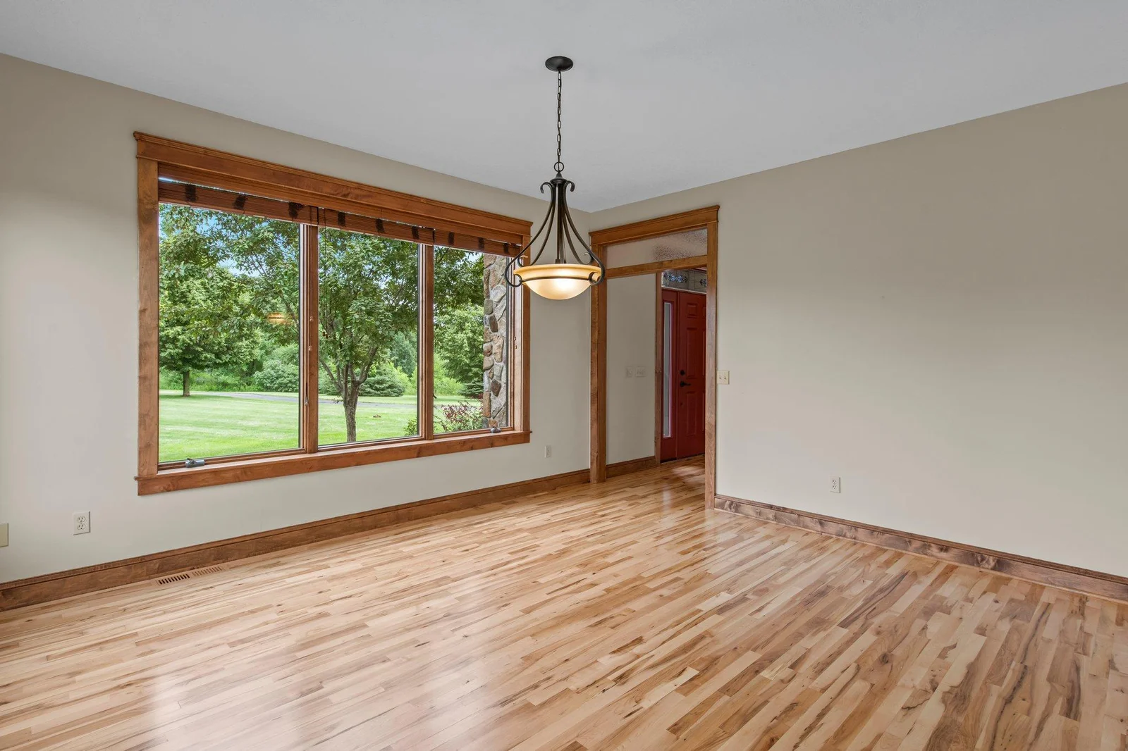 The dining area features beautiful hardwood floors and large windows.