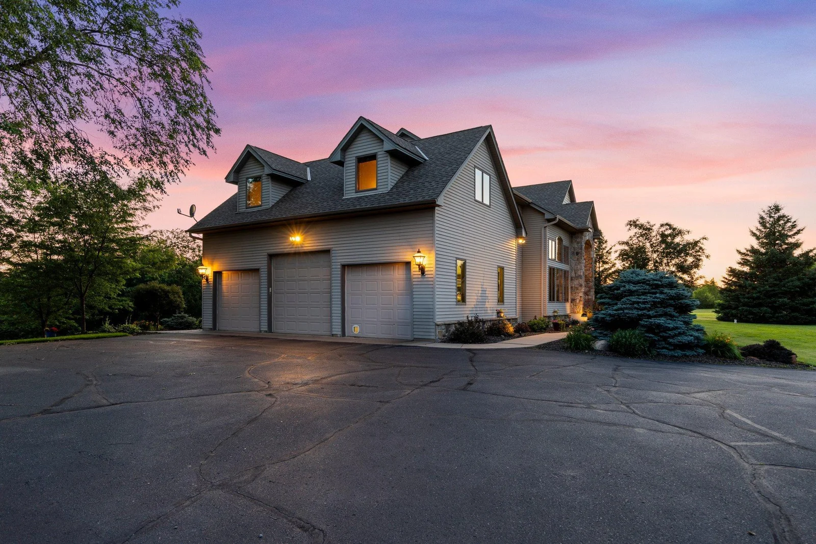 This home features an asphault driveway and an attached heated and insulated 3-car garage.