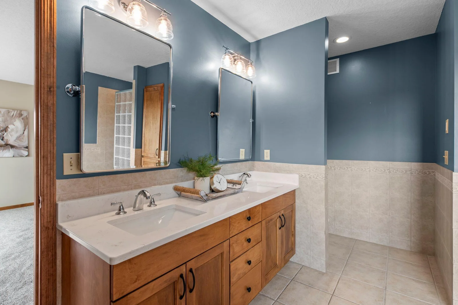 The primary ensuite bathroom features double sinks, a jetted tub and a separate shower.