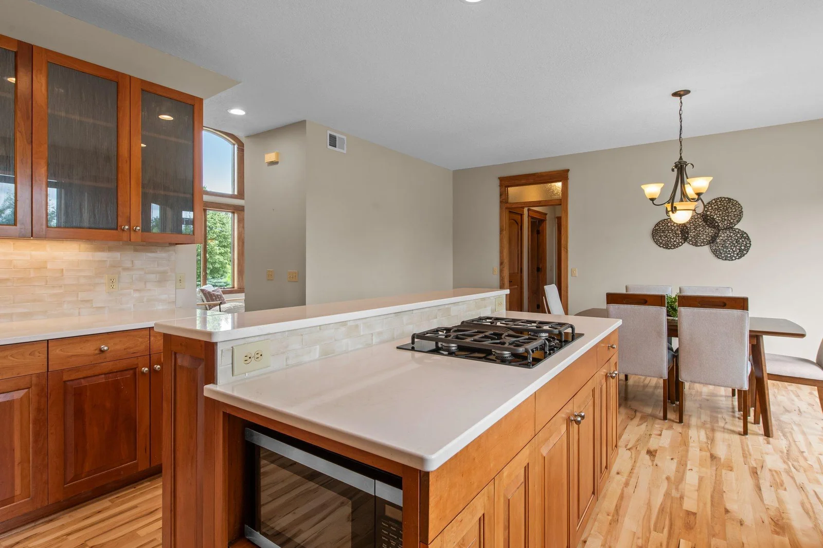 The gourmet kitchen includes custom cabinets, a double oven, cooktop and a stainless steel appliance package.