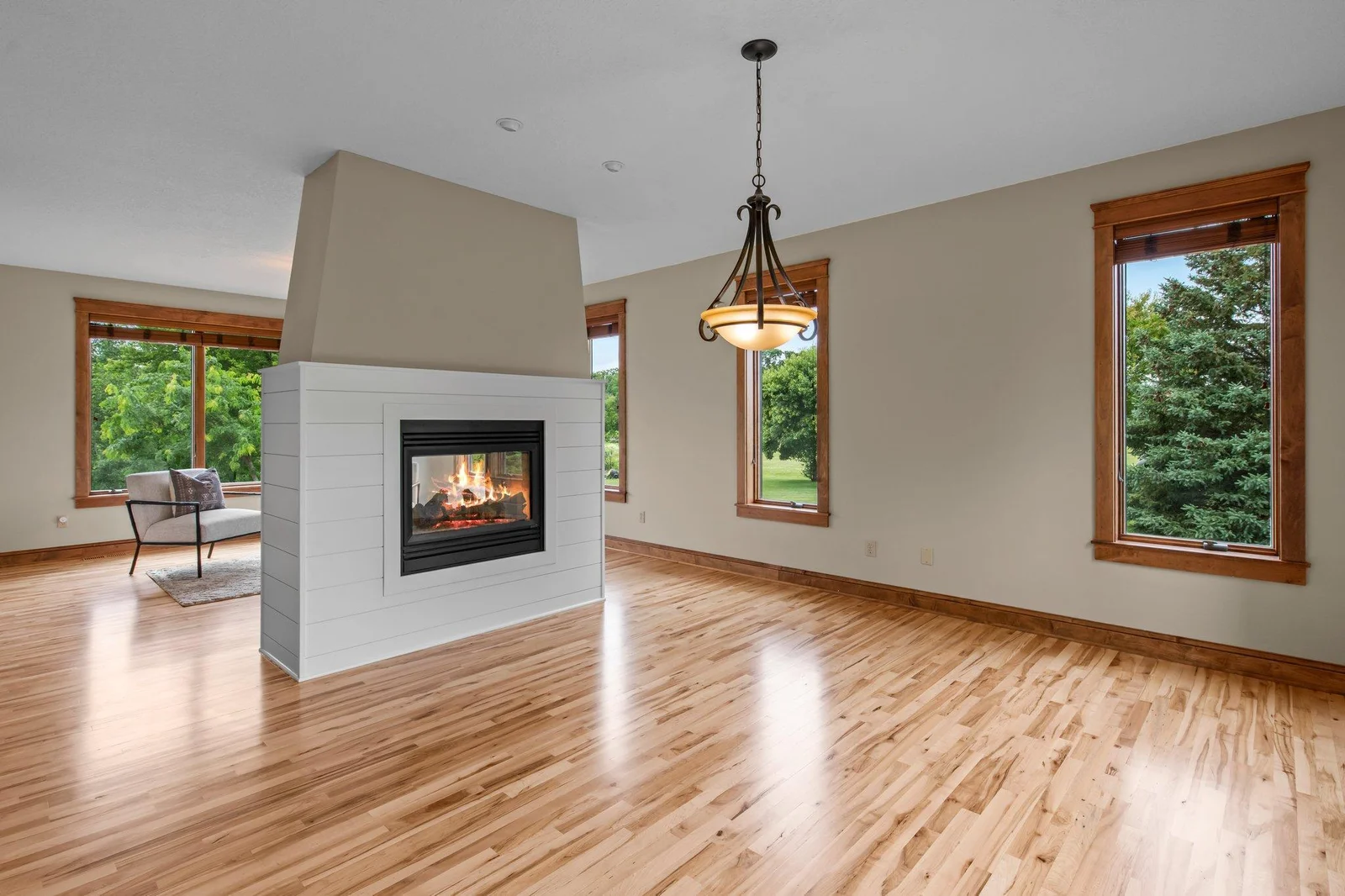 The double sided fireplace is the perfect centerpiece for this home.