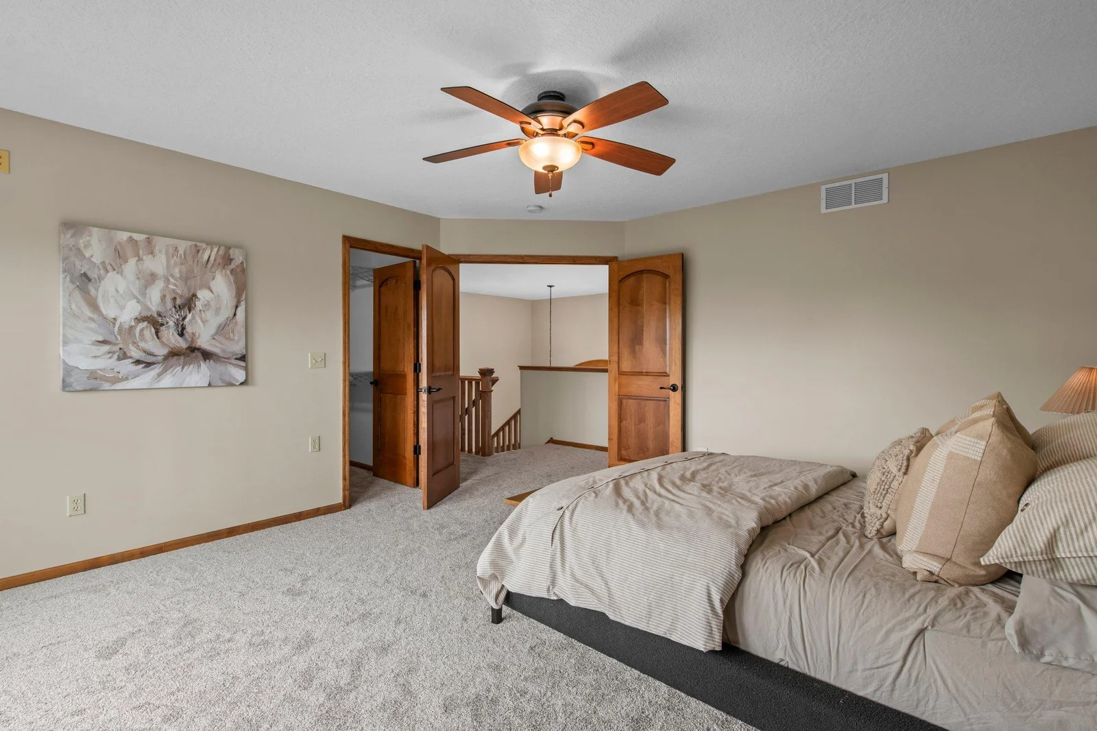 The primary suite features a massive walk-in closet, private bathroom and a balcony overlooking the pool.