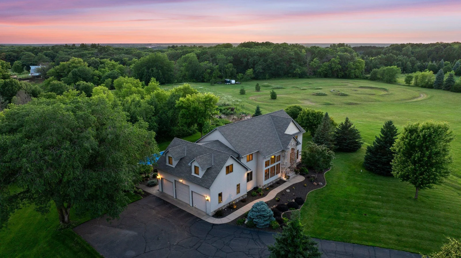 This gorgeous estate sits on 15 secluded acres and includes a pool and a pole building.