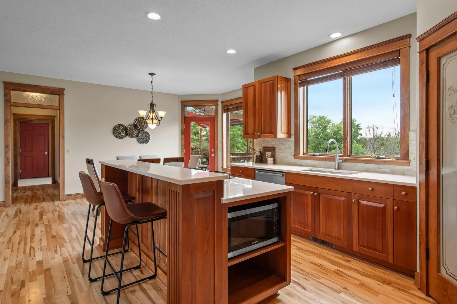 The gourmet kitchen includes custom cabinets, a double oven, cooktop and a stainless steel appliance package.