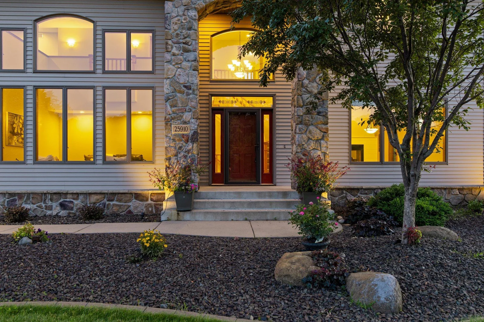 This home features aluminum siding and a stone archway over the front entry.
