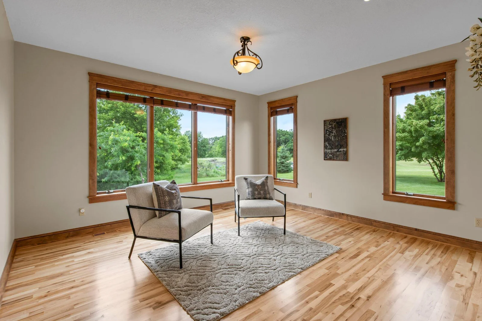 The family room features hardwood floors and windows overlooking the backyard.
