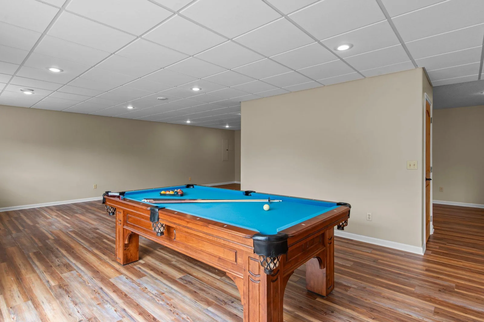 The expansive lower level recreation room includes hardwood floors.