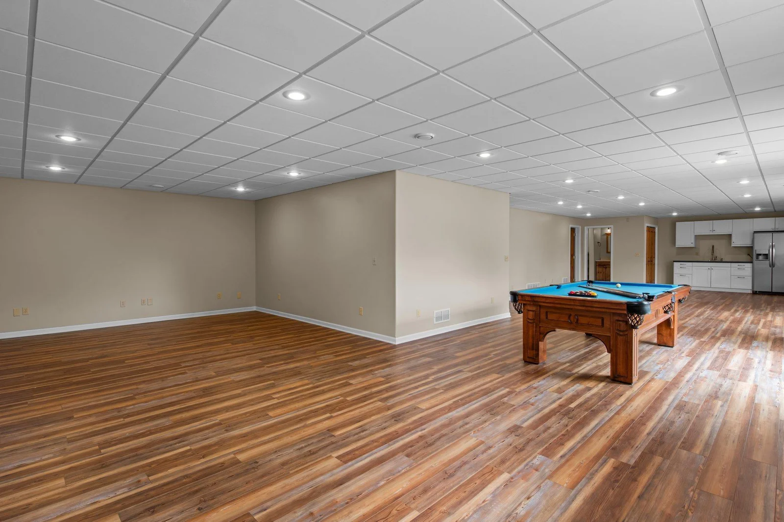 The expansive lower level recreation room includes hardwood floors.