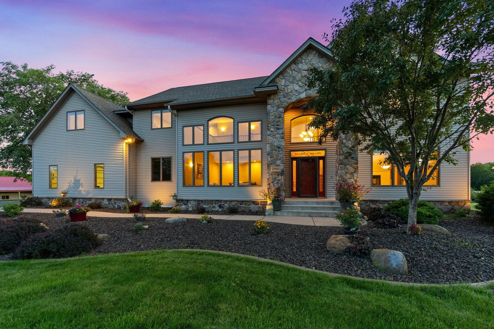 This home features aluminum siding and a stone archway over the front entry.