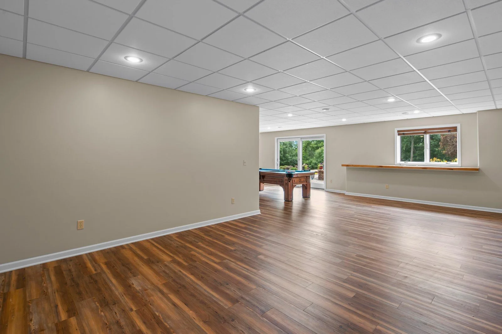 The expansive lower level recreation room includes hardwood floors.