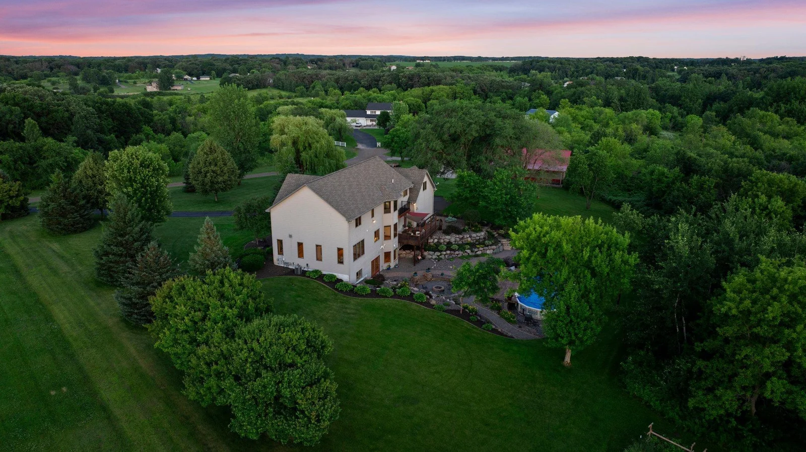 The backyard is an oasis, featuring stunning landscaping and a pool.