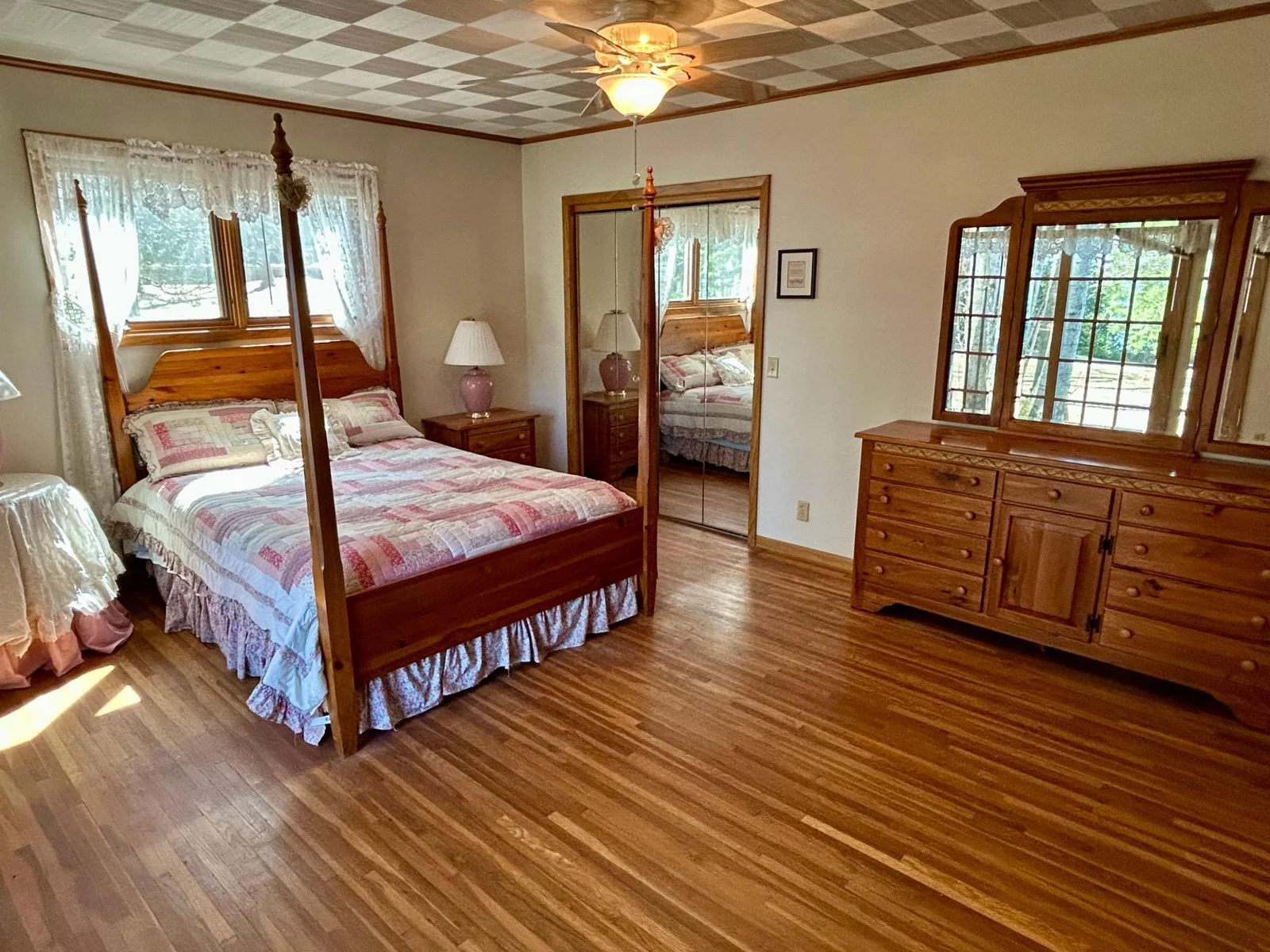 Primary Bedroom with beautiful hardwood flooring and lots of light