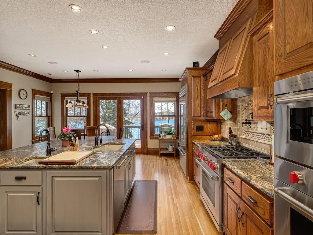 custom-made Vent-A-Hood mounted above a gorgeous mosaic travertine tile backsplash