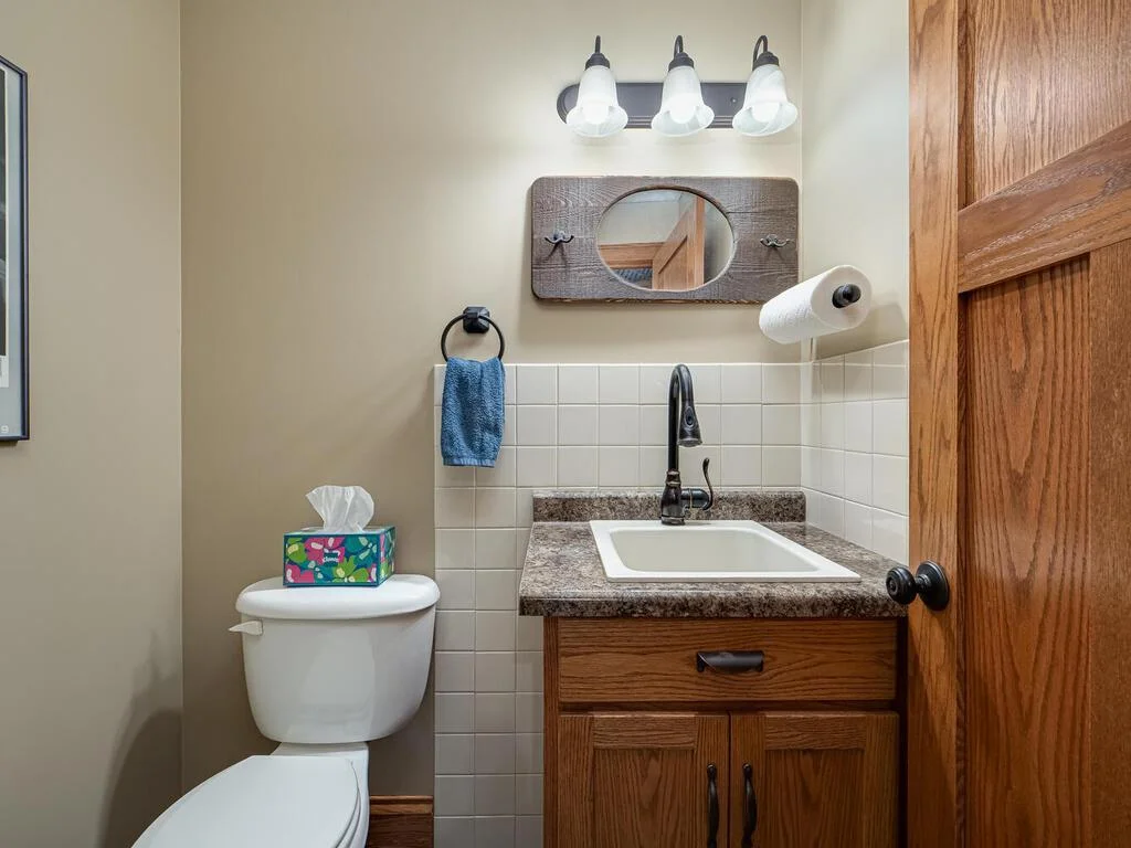 Lower level half bath just off the wood shop