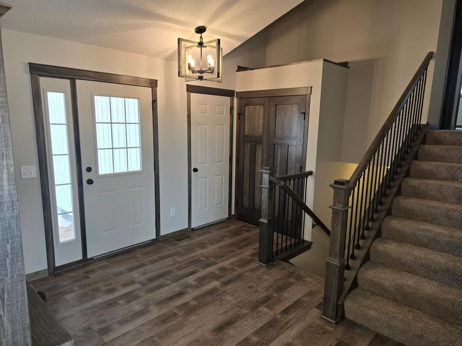 Nice luxurious vinyl plank flooring in the entrance area. Wood/Iron railing system on the stairway going up and down.
