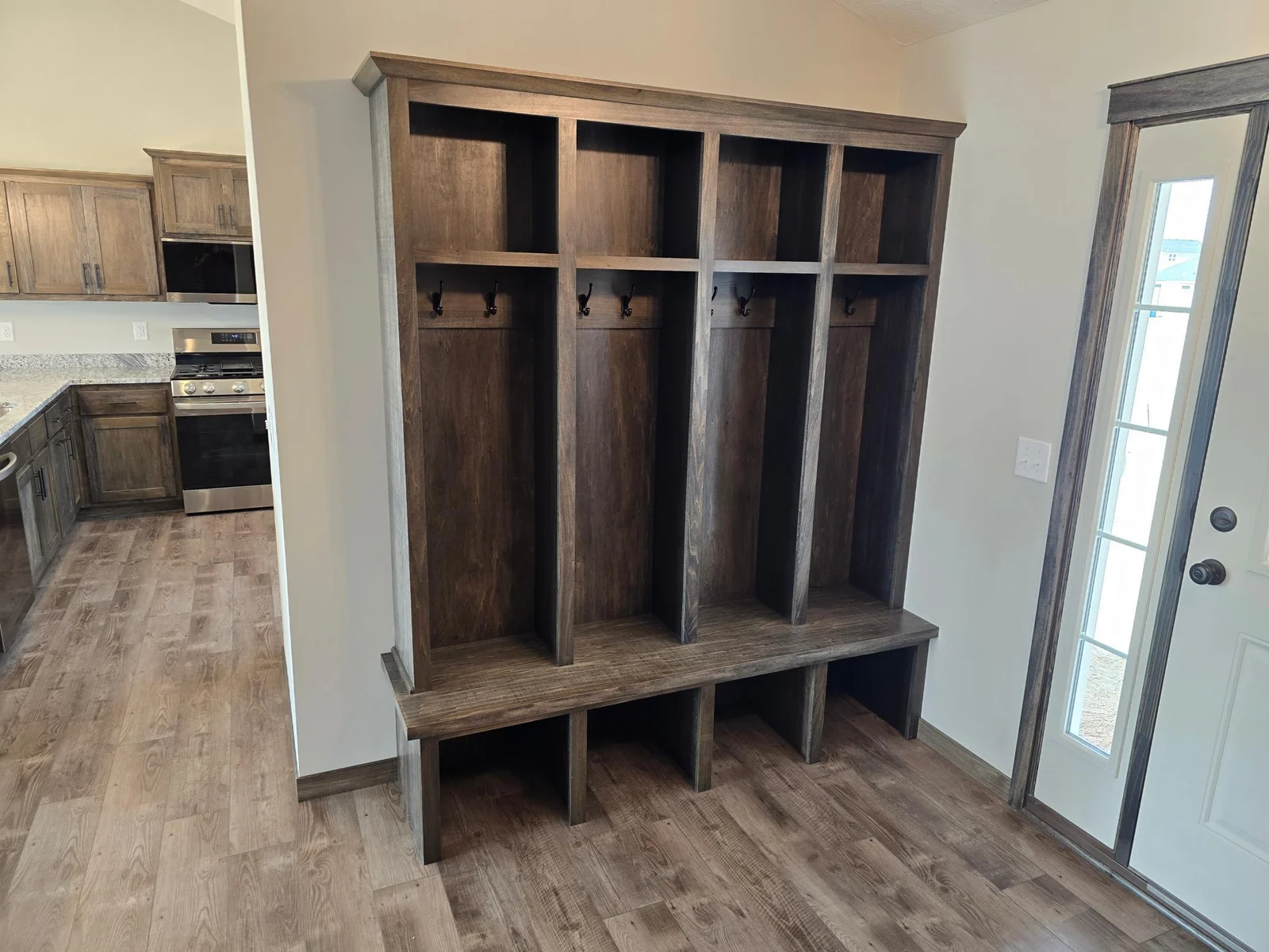 Custom bench and upper locker system with hanging hooks that will keep everyone organized and ready to go. Great unloading zone.