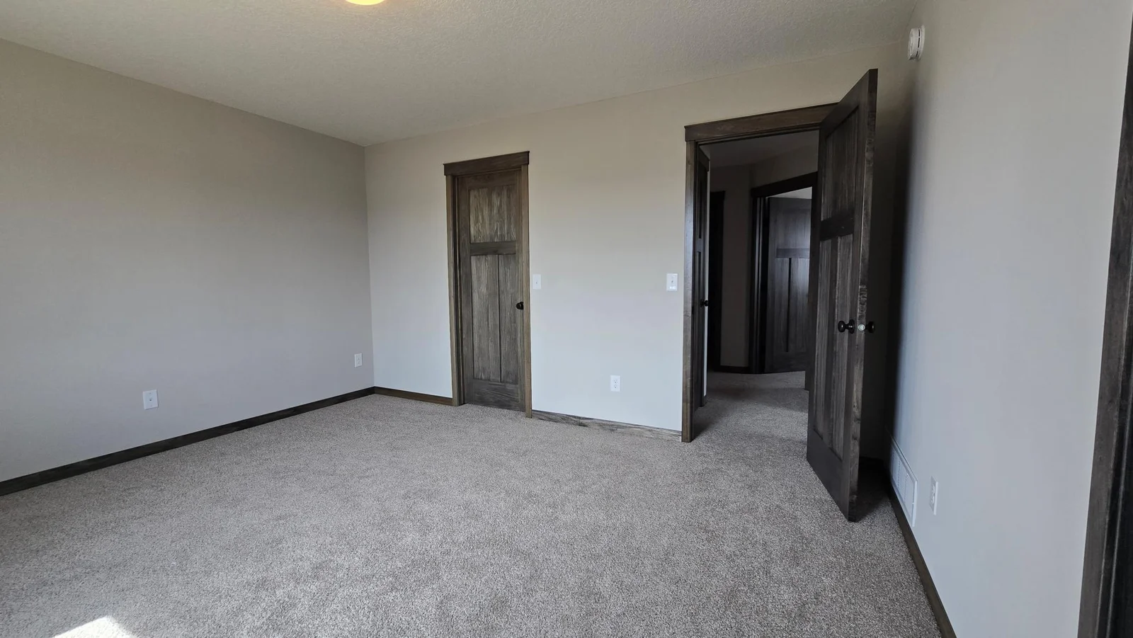 The entrance and walk in closet door in the primary bedroom.