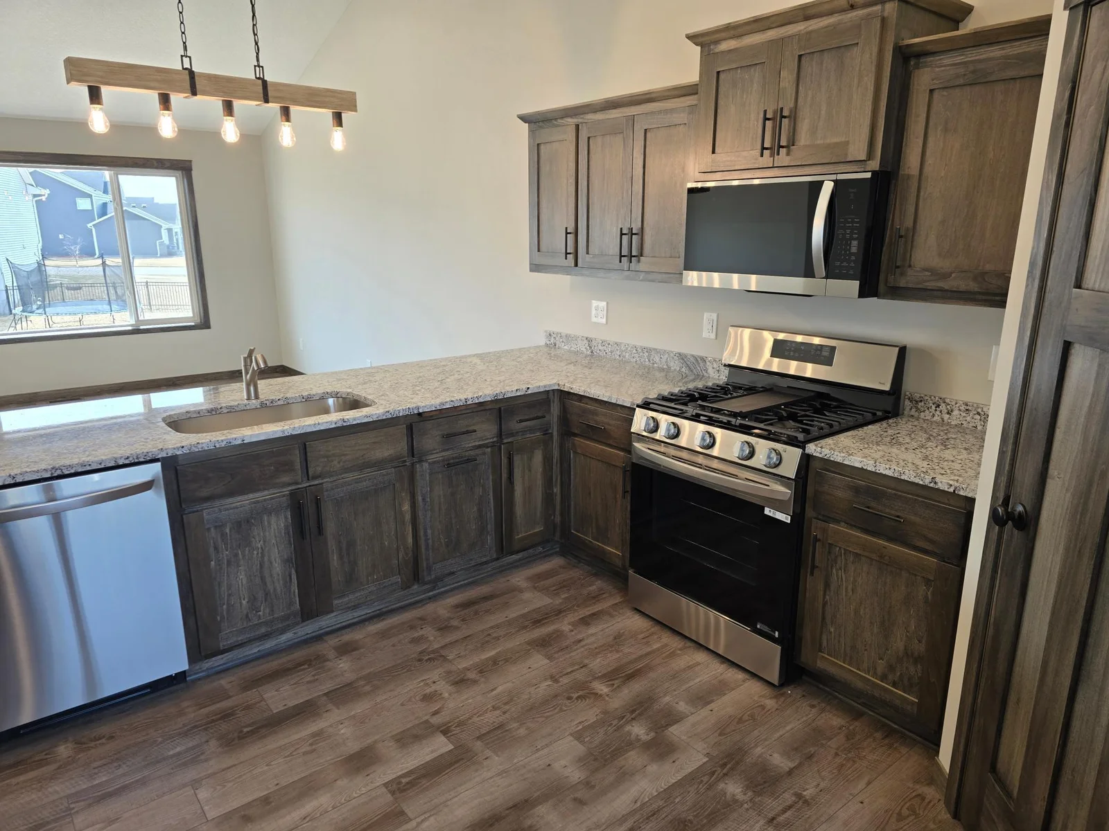 Lots of custom built popal cabinetry and desirable luxurious vinyl plank flooring.