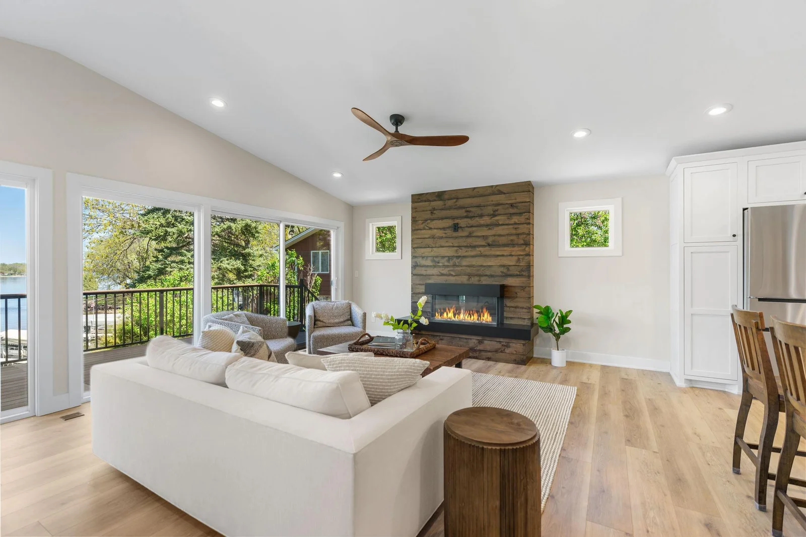 Great Room offers an electric fireplace that features a rustic alder paneled surround