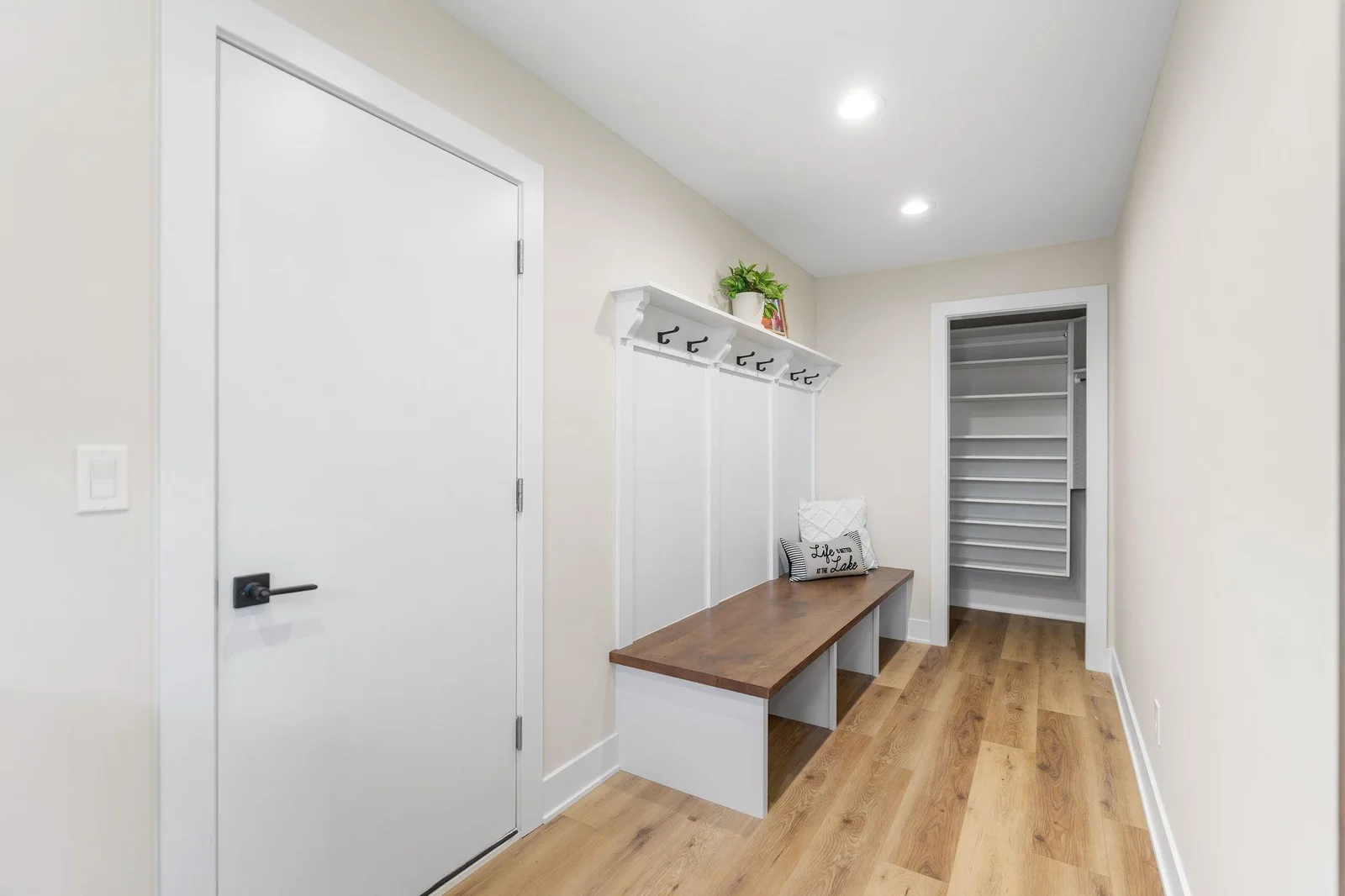 The Mudroom features large bench w/ alder top and paneled accent wall w/ hooks - walk-in closet w/ professionally installed organizer