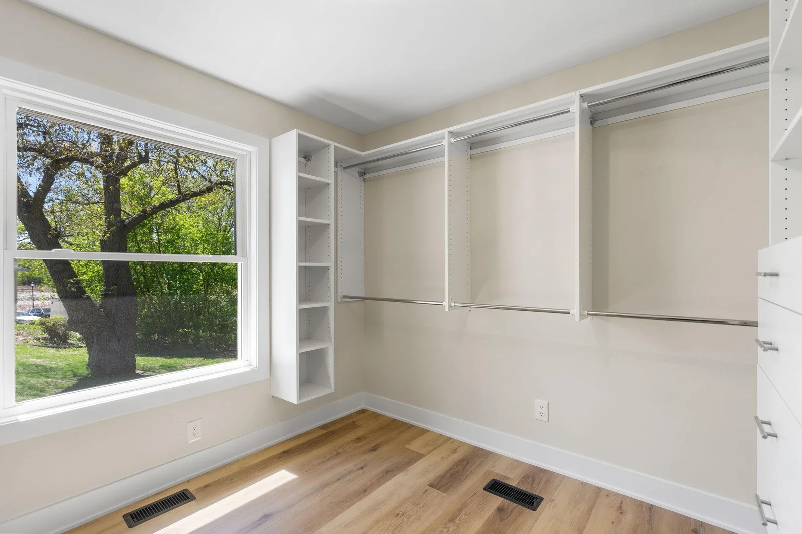 Spacious walk-in closet offers professionally installed organizer
