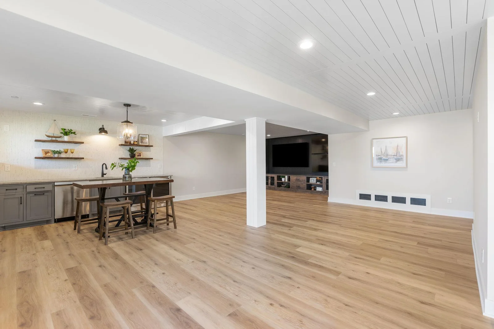 The Lower Level features enameled wood paneled ceilings and so much room!