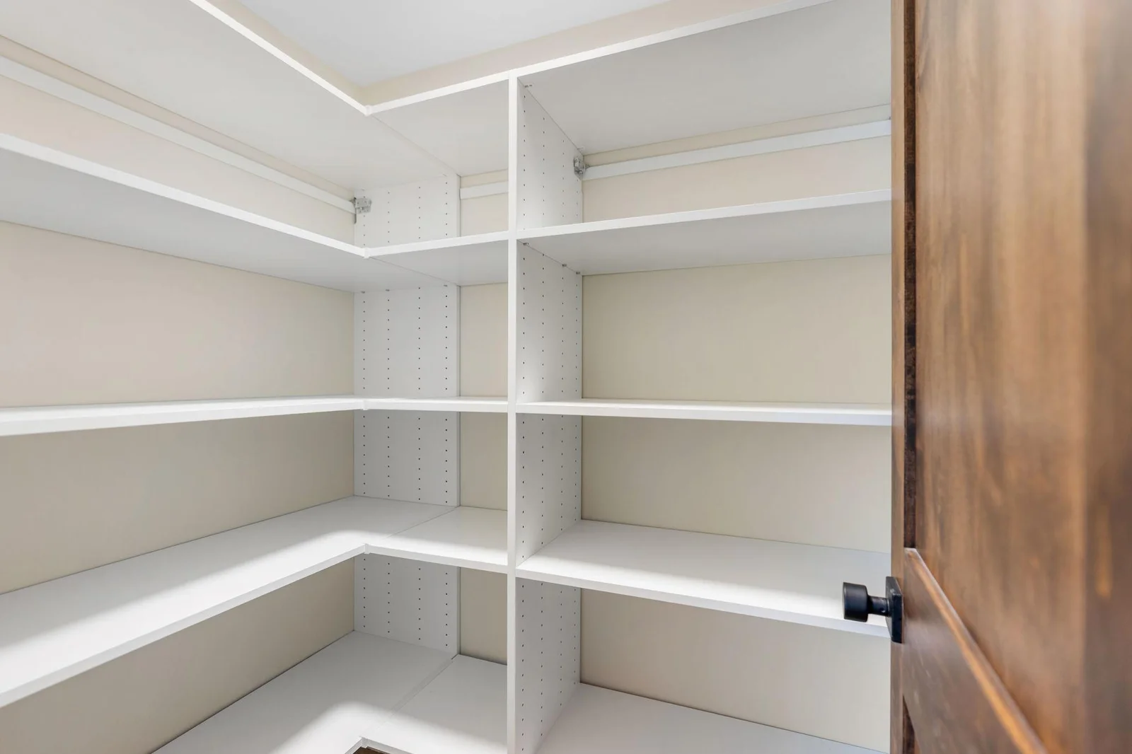 Walk-in closet with professionally installed organizer in the hallway for storage!