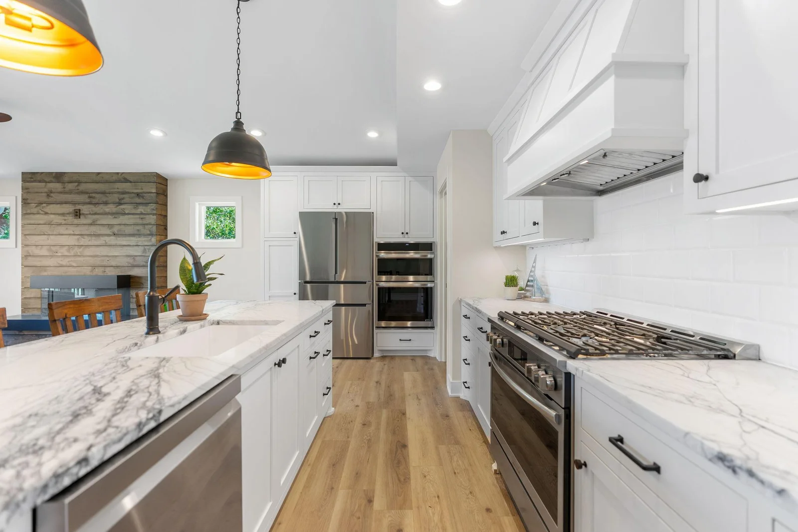 Stainless steel appliances include a 36" gas range w/ cabinet paneled hood, dual wall oven w/ convection microwave, french door refrigerator and dishwasher