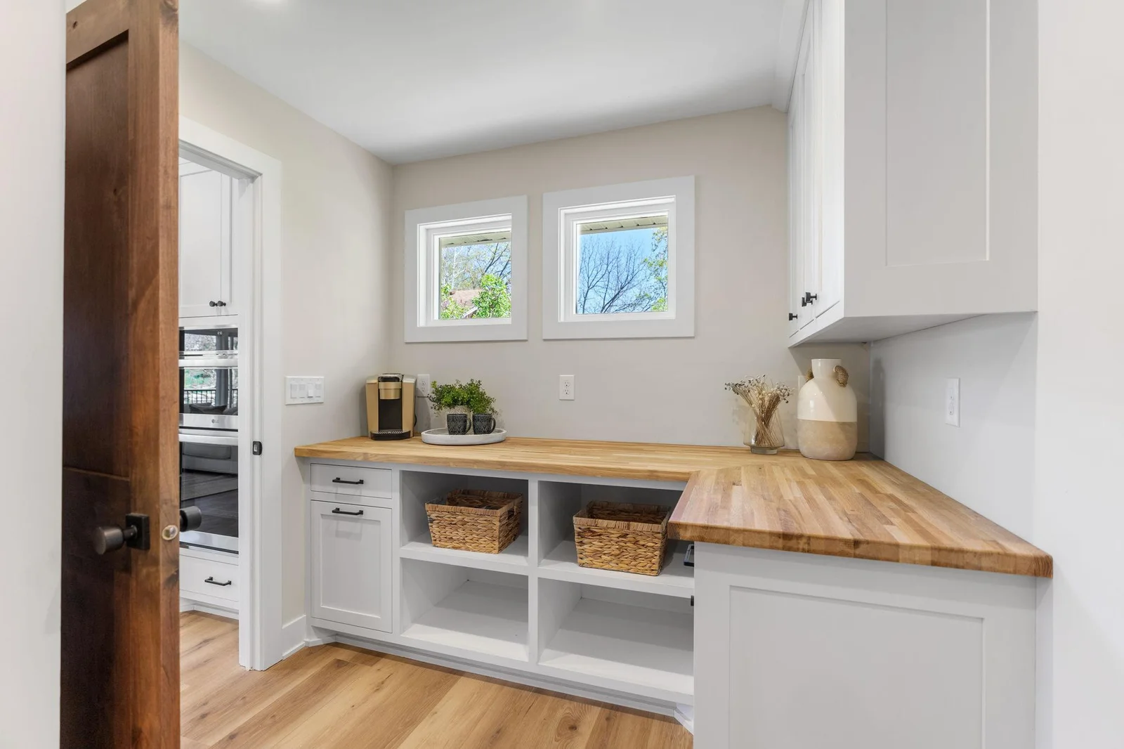 The Pantry features enameled cabinetry that offers storage and open shelving, white oak butcher block countertop