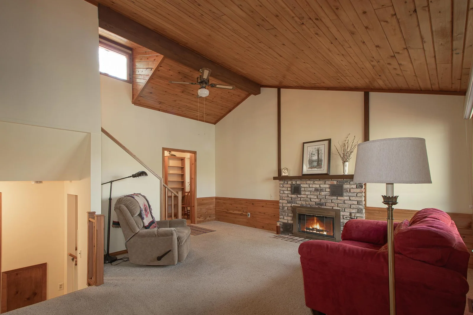 Main level living area fireplace - beautiful wood vaulted ceiling w/ceiling fan