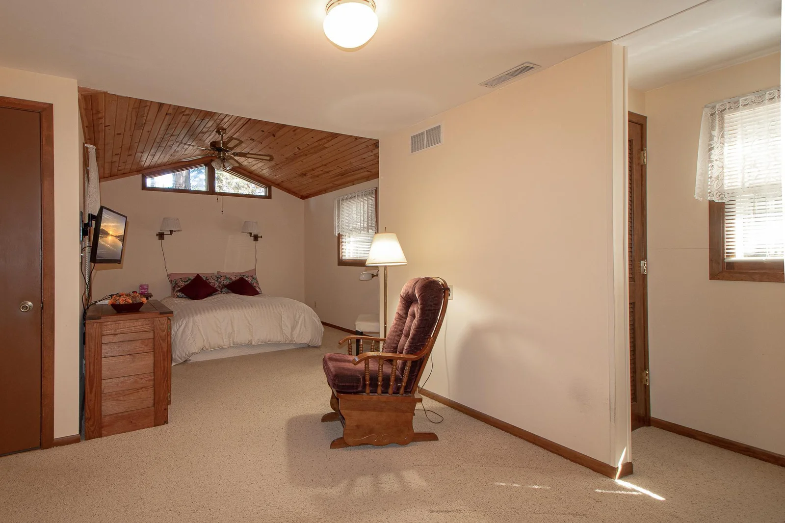 Beautiful wood vaulted ceiling w/fan - love the window above bed