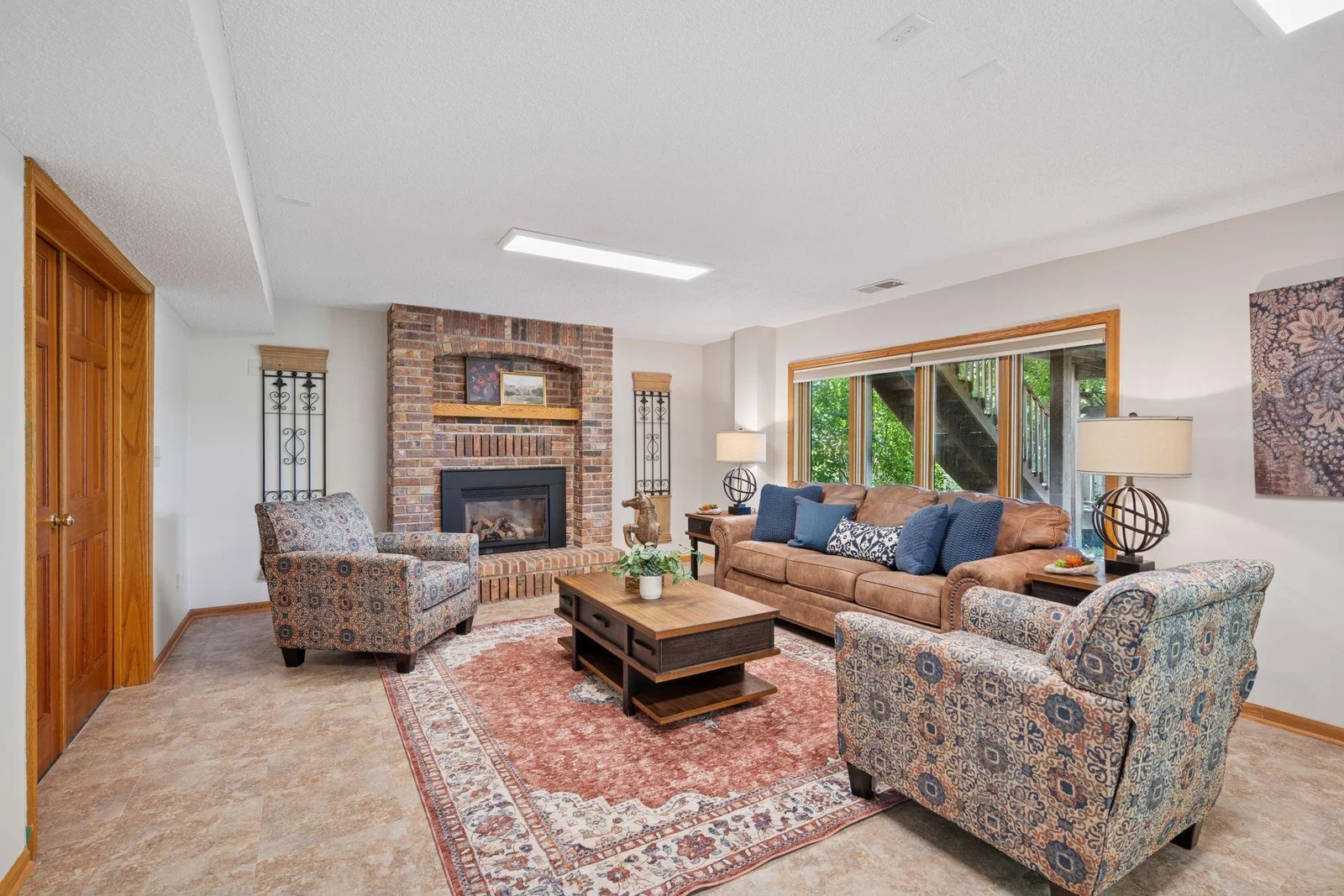 Cozy family room in lower level complete with gas fireplace insert is a great getaway or kid cave.