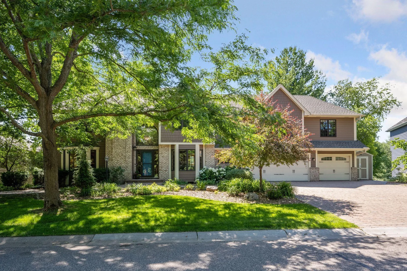 Timeless two story home with great curb appeal, paver driveway, lush landscaping and additional storage shed, directly across from park trails.    Hurry home!