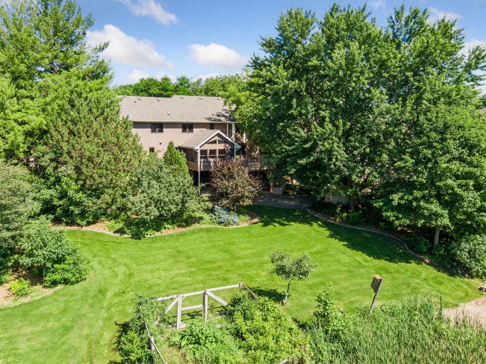 The backyard is an oasis, filled with nature and beautiful blooms.   A variety of fruit trees with wild berries, pond, lakefront and dock.   Hard to find a nicer lot in the neighborhood!
