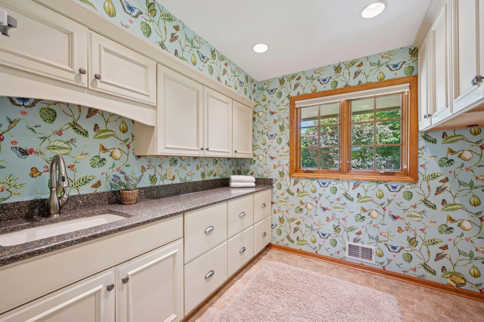 Main floor laundry with beautiful cabinetry and drop in sink.