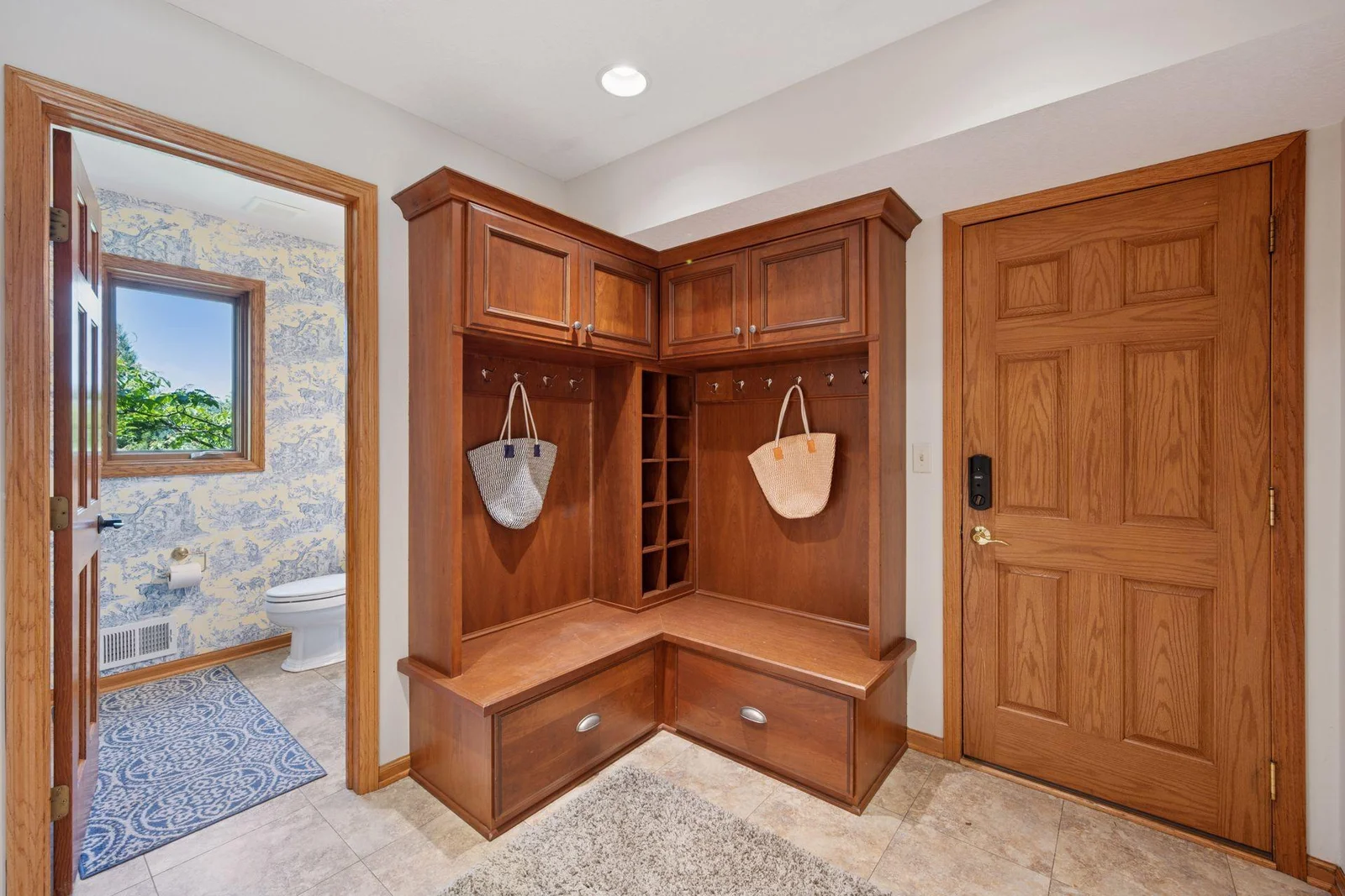 Mudroom off the garage with bench & storage, powder room and main floor laundry.