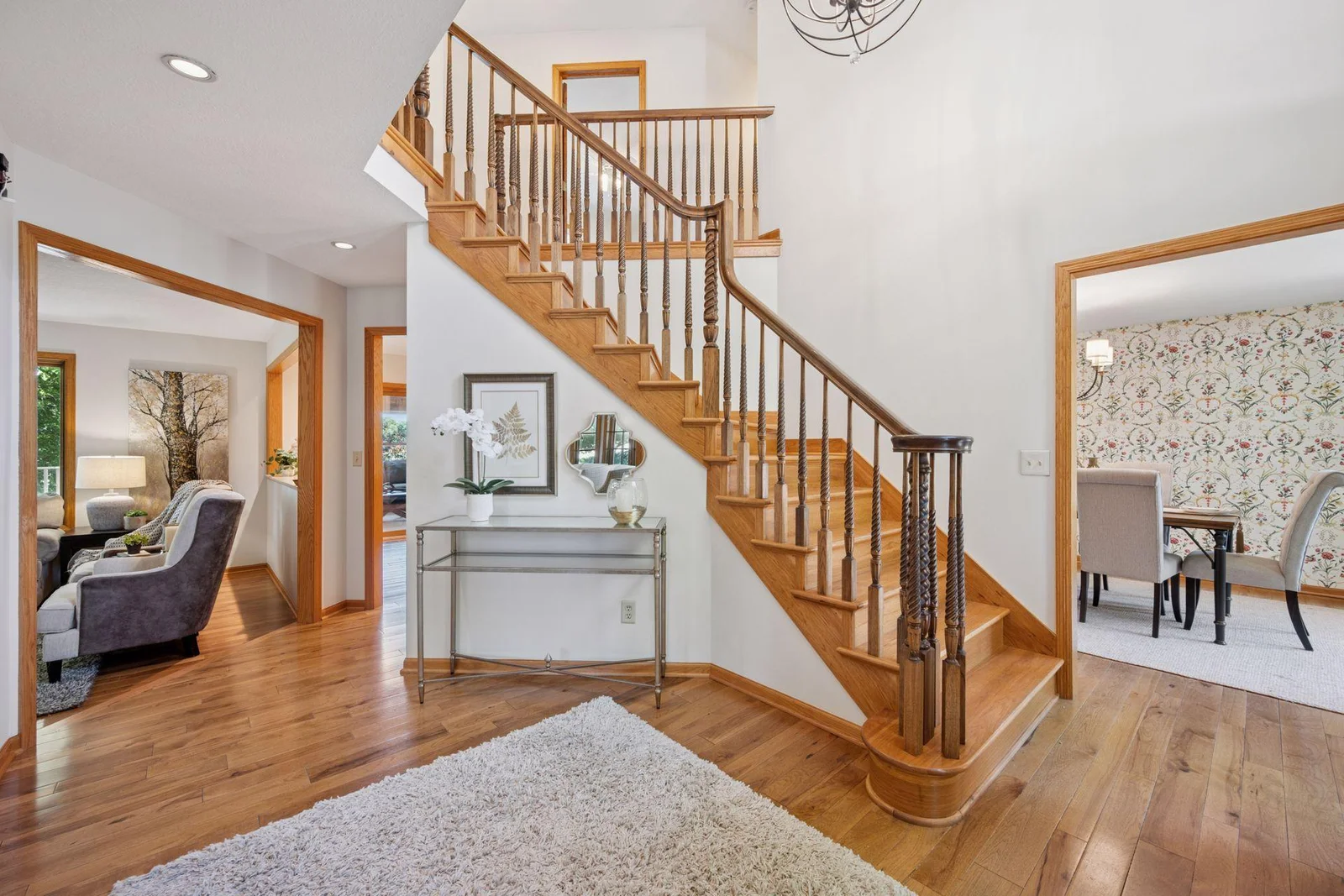 Beautiful open staircase, gleaming wood floors and dramatic foyer welcome you into this lovely home.
