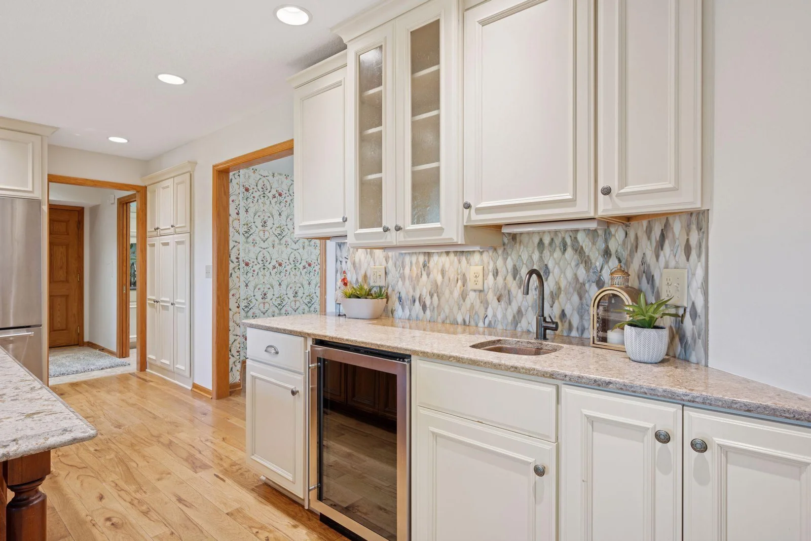 Under counter wine fridge with prep sink and gorgeous custom designed cabinets.