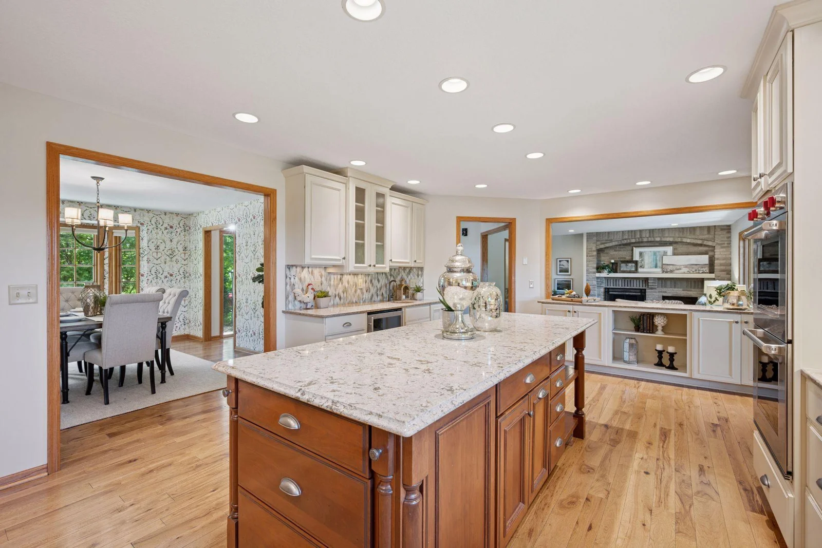 Sophisticated and classy the kitchen is the centerpiece and will be the envy of everyone that enters.  Large center island, granite countertops, enameled cabinetry, double oven, gas cooktop, wine fridge and walls of cabinets provide great storage.