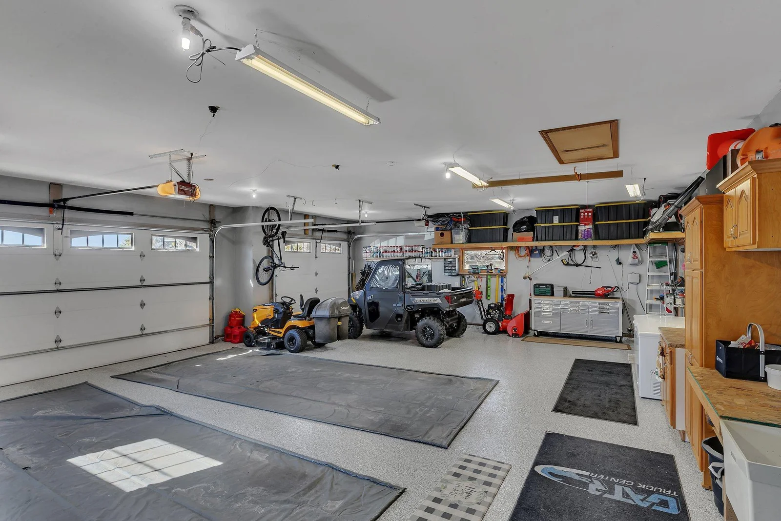 Garage has heat, insulation, pollied floors, great lighting, overhead storage and built in storage.