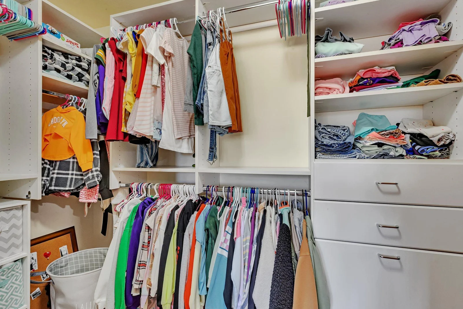 Walk in closet with more built ins.