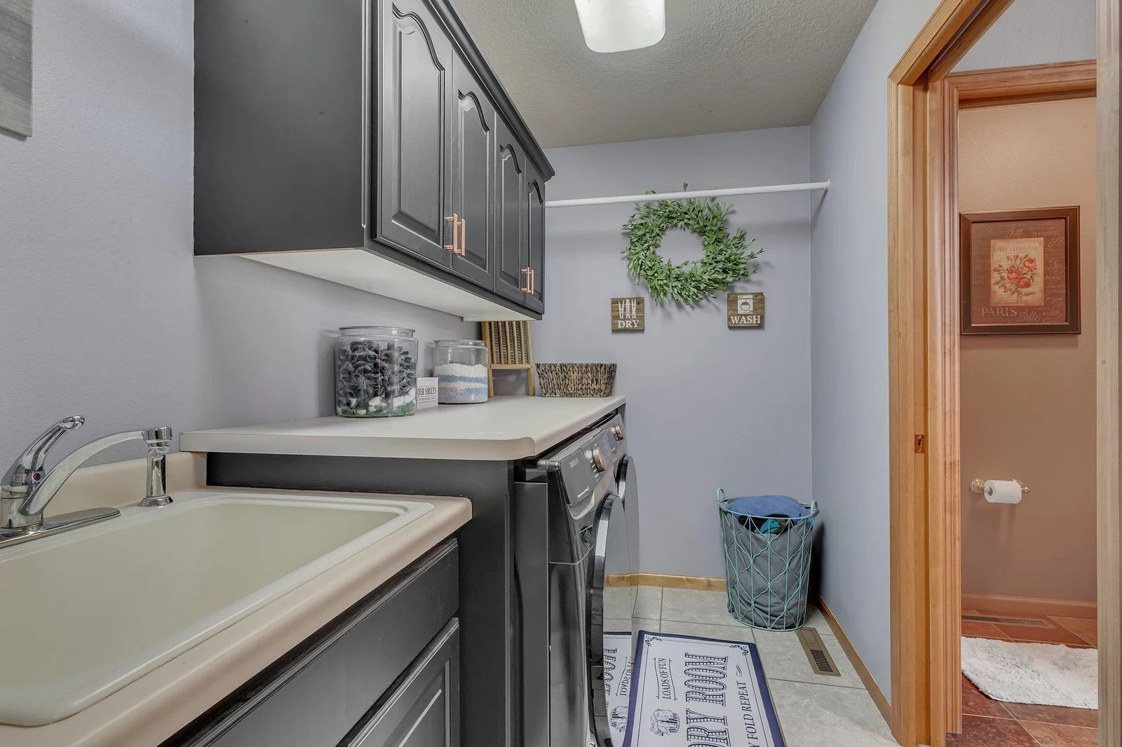 Laundry room is located on the upper level with great storage and a folding counter.  Pocket doors lead to primary owners full bath.