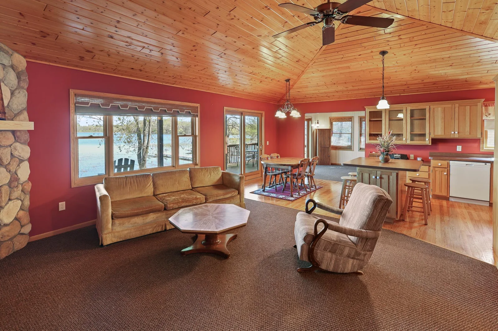Living room into the dining area. Note the great windows looking over the lake.