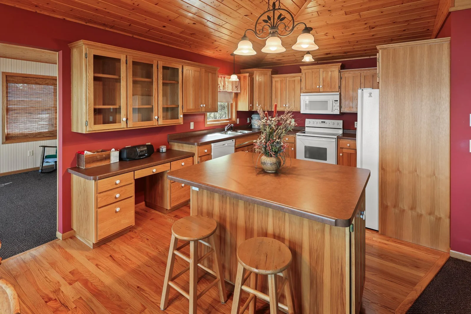 Center island, wood floors, beautiful cabinets.